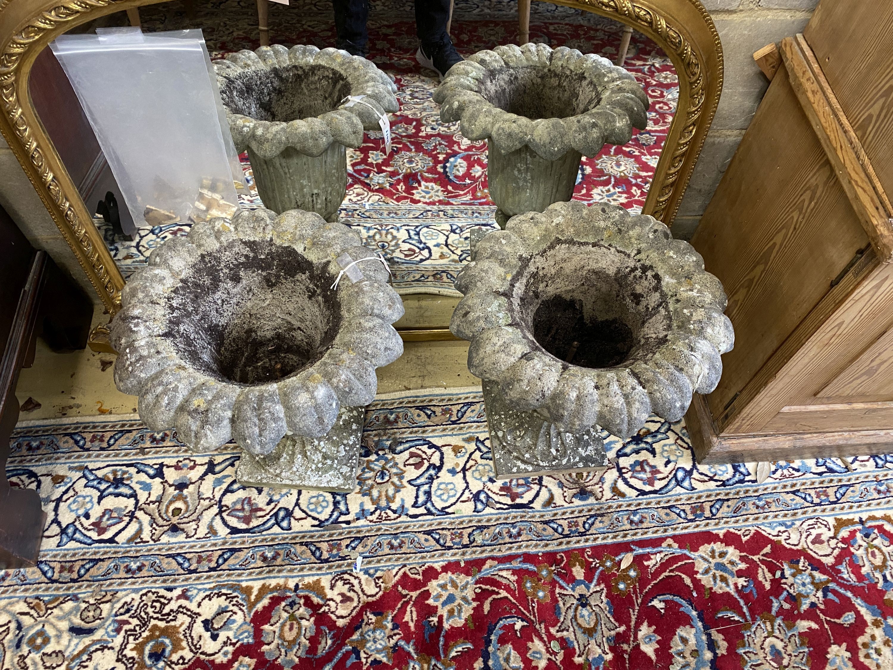 A pair of reconstituted stone campana garden urns on bases, diameter 42cm, height 46cm